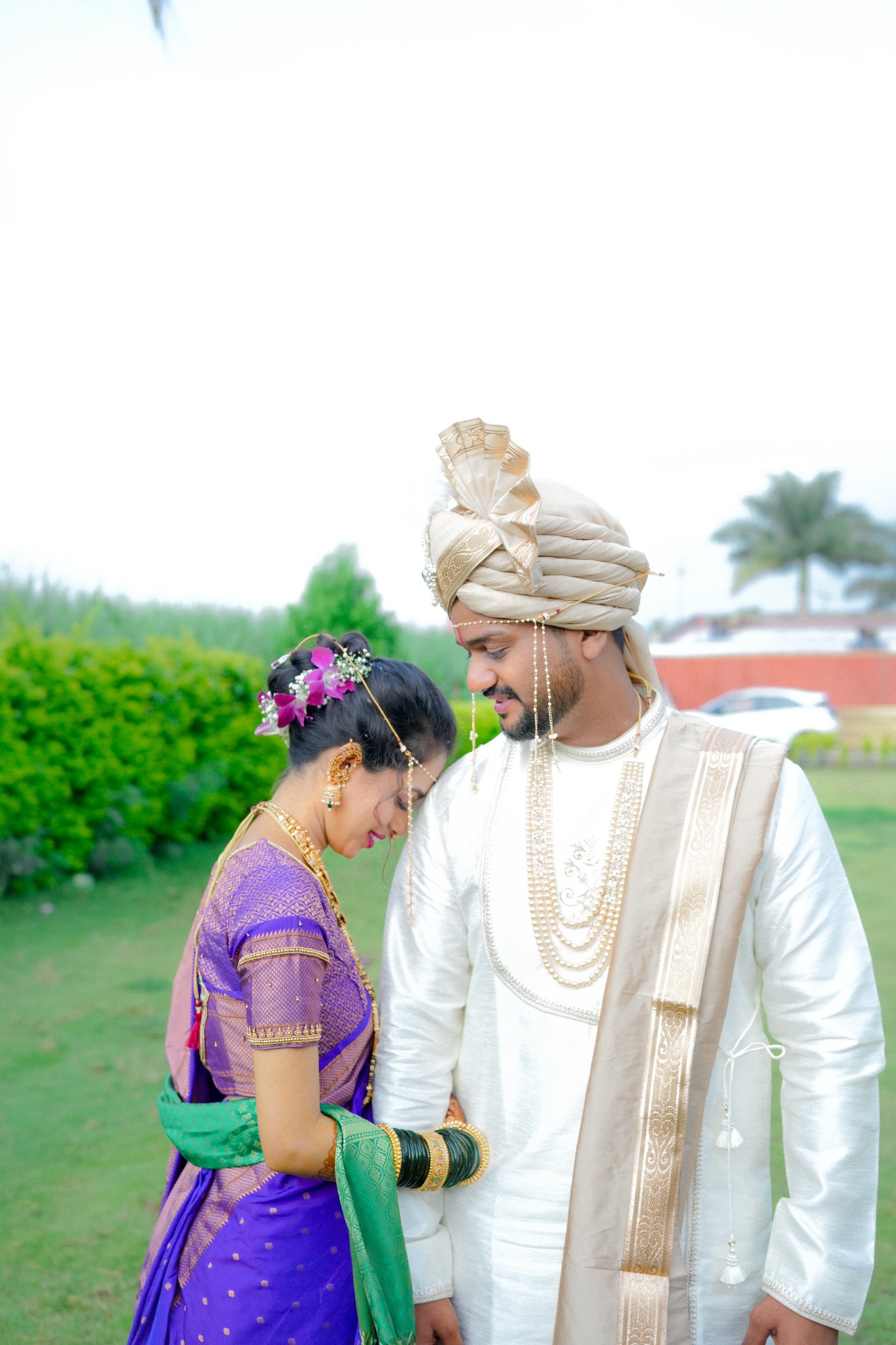A couple in traditional wedding attire sharing a tender moment